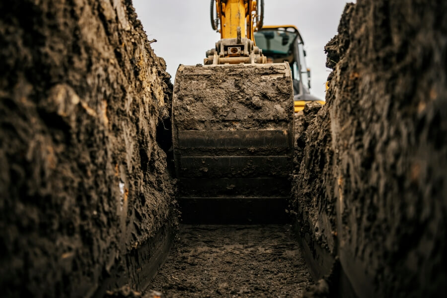 Excavator Digging a Trench with Bucket Attachment